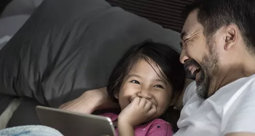 A father and daughter laughing