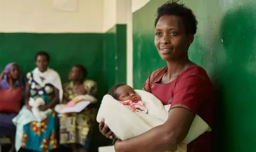 Mother waiting with an infant in a clinic