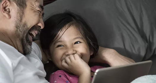 A father and daughter laughing